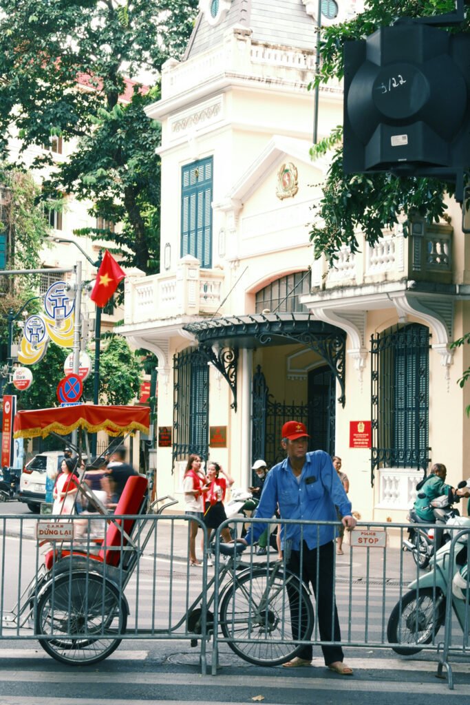 man waiting by a bicycle and staring off into traffic