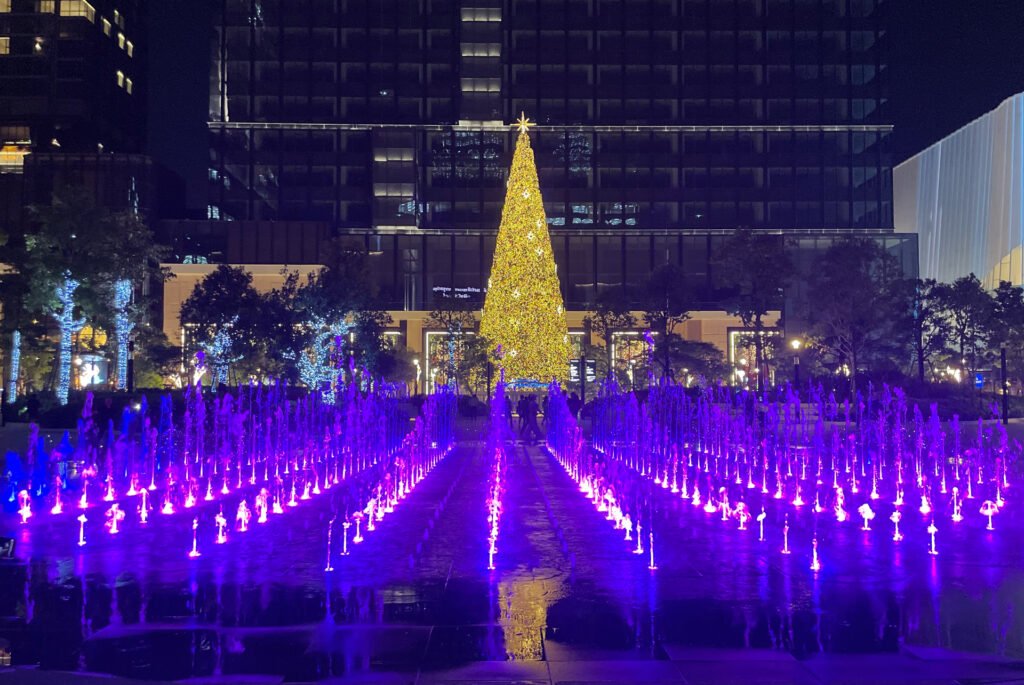 Big gold christmas tree with purple fountain below