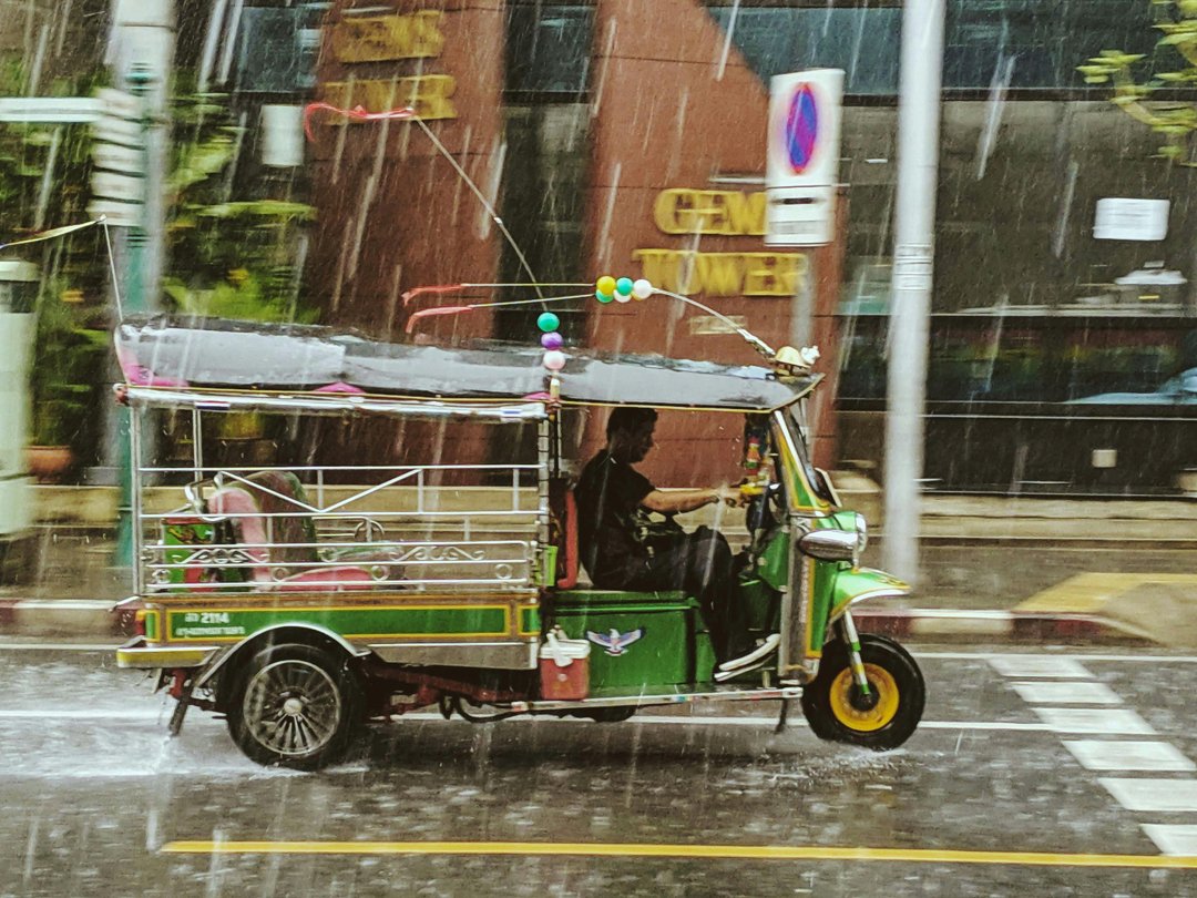 tuk-tuk-driver-riding-in-the-rain