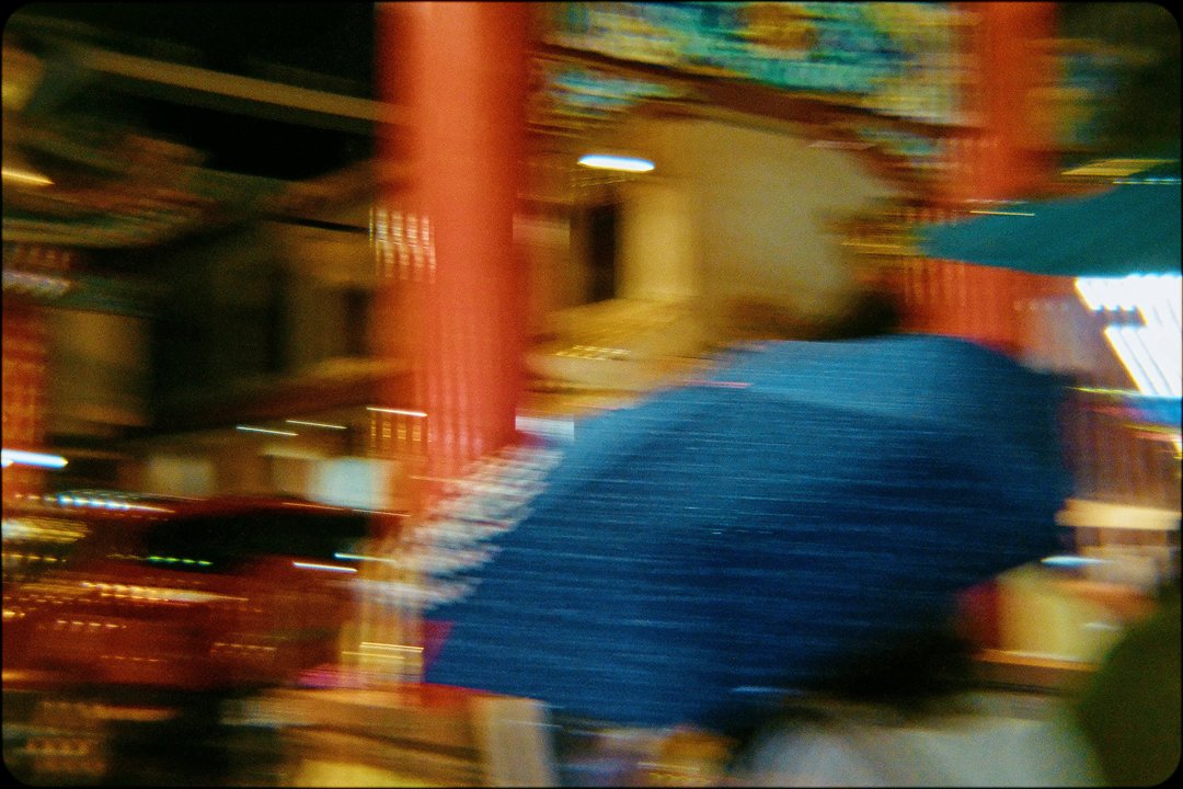 person carrying an umbrella in a rainy day in bangkok