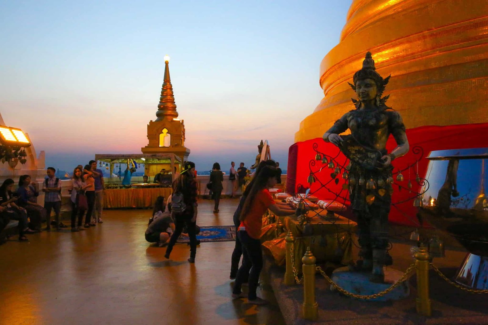 Families walking around the bottom of Wat Saket