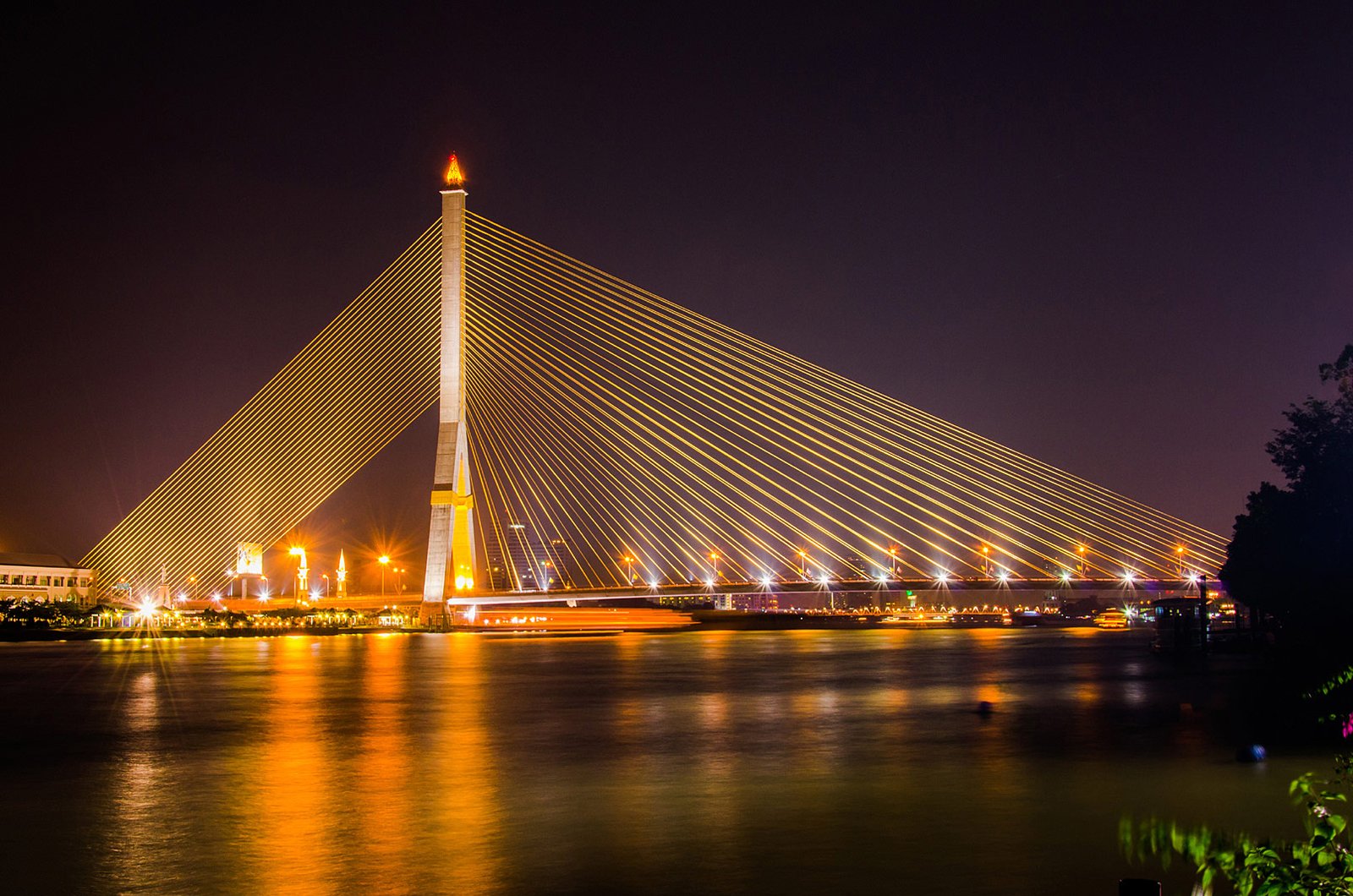 View from the park of Rama VIII Bridge lighting up the night sky