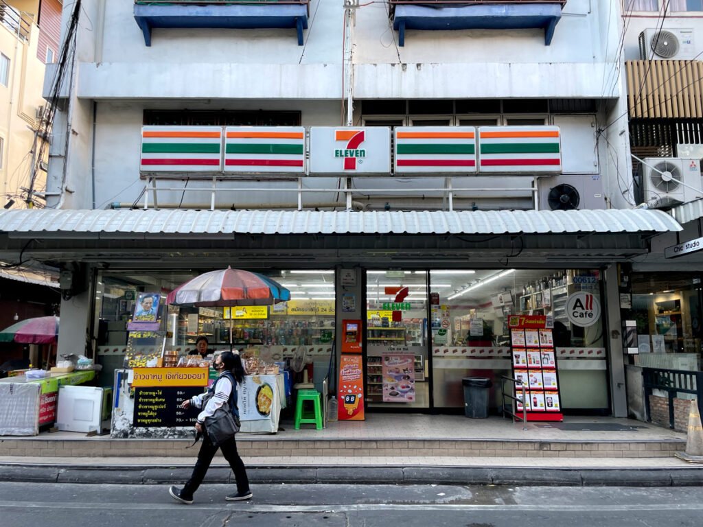 Person walking past a 7-eleven store