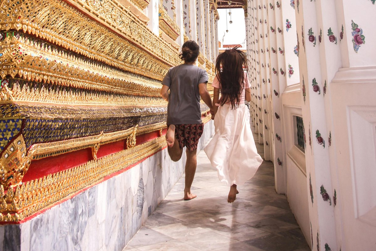 Couple running through temple on valentine's day bangkok
