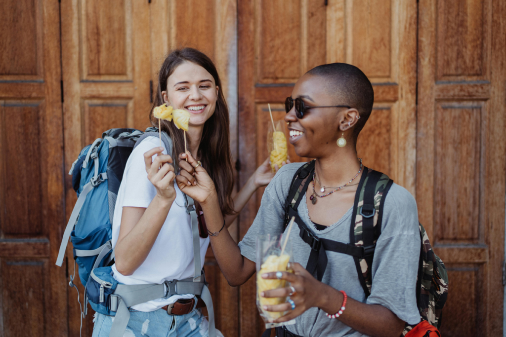 Two women share pineapples in Bangkok