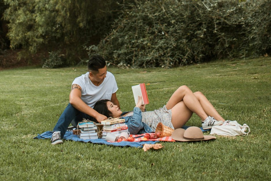 man and woman reading a book in Benjakitti Park