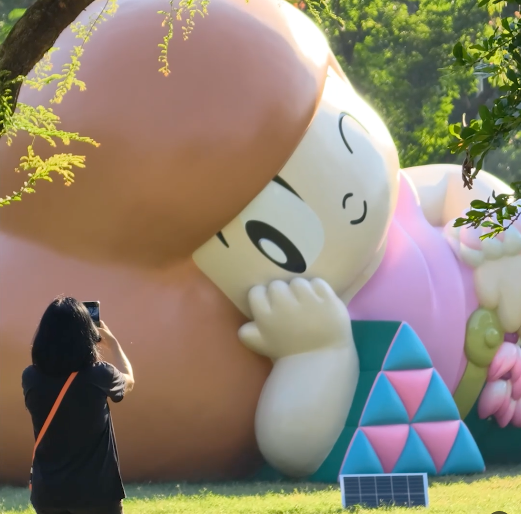 Woman taking picture of art sculpture in Bangkok