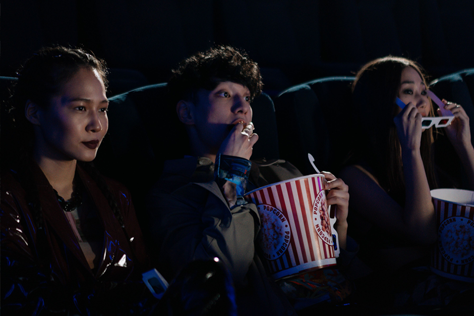 People eating popcorn and watching a movie in Bangkok.